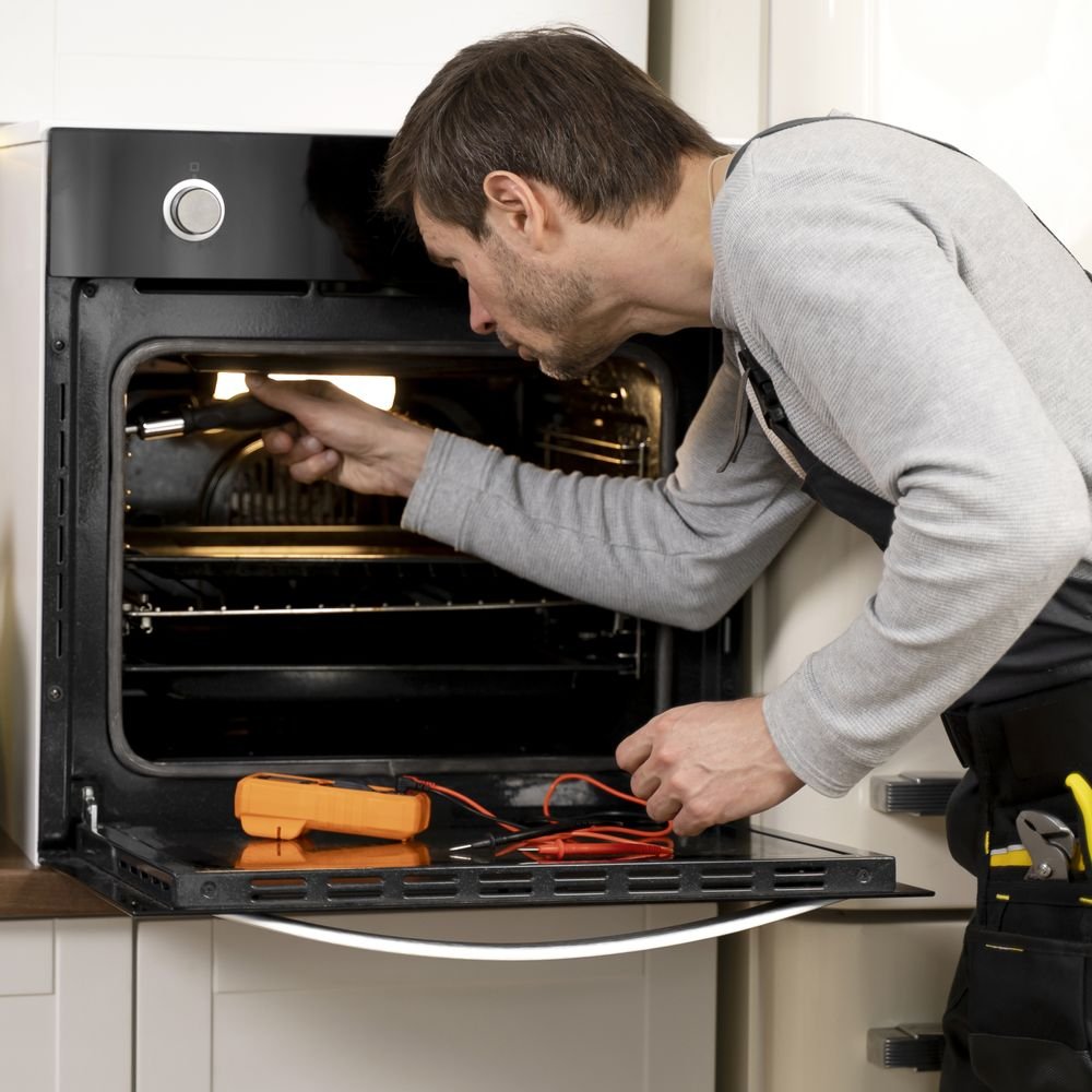 Technician repairing a microwave oven in Hyderabad