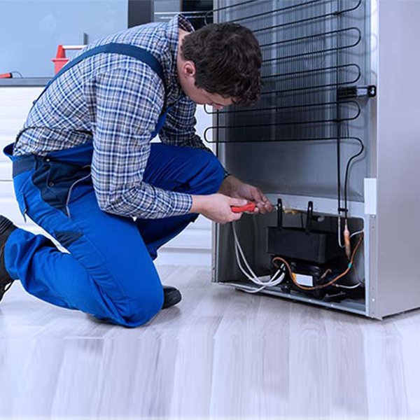 Technician repairing a refrigerator in Hyderabad