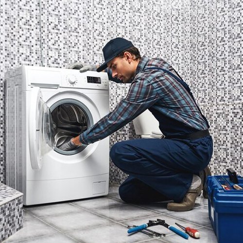 Technician repairing a washing machine in Hyderabad